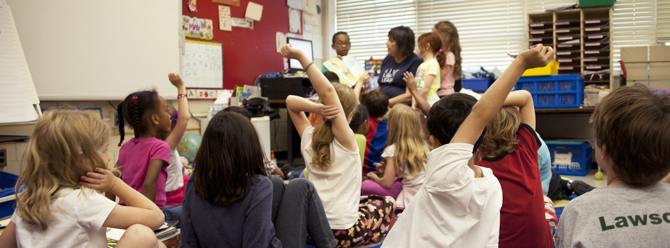 Young children reading colorful picture books in a library